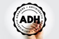 ADH Antidiuretic Hormone displayed inside a circular stamp design with visible hand drawing the emblem, featuring bold typography Royalty Free Stock Photo
