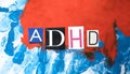 ADHD. Abbreviation ADHD from paper letters . Chaotic blue red stripes background. ADHD is Attention deficit hyperactivity disorder