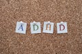 ADHD letters pinned to a cork notice board