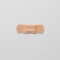Adhesive bandage on a plain white surface, rectangular with rounded ends. Made of Royalty Free Stock Photo