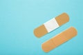 Adhesive bandage sticking plaster on blue background. Space for text Royalty Free Stock Photo