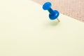 Adhesive note and blue pushpin