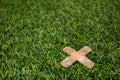 Adhesive plasters sticked to green grass close up