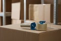 Adhesive tape dispenser on cardboard box indoors. Space for text Royalty Free Stock Photo