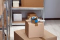 Adhesive tape dispenser on cardboard box indoors. Space for text Royalty Free Stock Photo