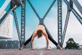 Adho Mukha Svanasana practiced by a young outdoor yoga enthusiast in the city