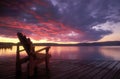 Adirondack chair on deck at sunrise. Royalty Free Stock Photo