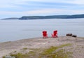 Adirondack chairs on the edge of a cliff overlooking the ocean and Avalon Region coastline Royalty Free Stock Photo