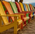 Adirondack Chairs lined up on a beach ready for summer vacationers