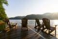 Adirondack deck chairs on lake dock Royalty Free Stock Photo