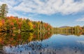 Adirondack lake in St Regis Wilderness with peak fall foliage on a peaceful calm morning Royalty Free Stock Photo