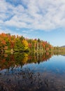 Adirondack lake in St Regis Wilderness with peak fall foliage on a peaceful calm morning Royalty Free Stock Photo