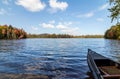 Canoe on Adirondack lake in St Regis Wilderness with peak fall foliage on a peaceful calm morning Royalty Free Stock Photo