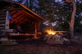 Adirondack Lean to Bushcraft camp shelter with fire at night in the mountains.