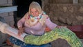 Turkish local woman gathering tobocco leaves with a machine later to leave them to dry, Turkey