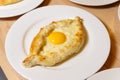 Adjarian Khachapuri with Egg on White Plate