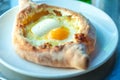 Adjarian khachapuri with eggs on the table