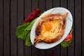 Adjarian khachapuri with eggs on wooden table