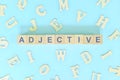 Adjective concept in English grammar and learning class lesson. Wooden blocks typography word flat lay Royalty Free Stock Photo