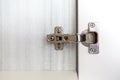 Adjustable concealed hinge fixed on a cabinet Royalty Free Stock Photo