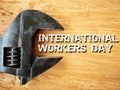 Adjustable spanner over the wood written INTERNATIONAL WORKERS DAY