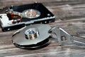 An adjustable spanner wrench and HDD platters together, hard disk drive disassembled damaged components, computer maintenance, Royalty Free Stock Photo