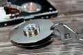 An adjustable spanner wrench and HDD platters together, hard disk drive disassembled damaged components, computer maintenance, Royalty Free Stock Photo
