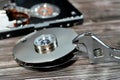 An adjustable spanner wrench and HDD platters together, hard disk drive disassembled damaged components, computer maintenance,