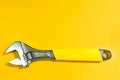Adjustable universal spanner wrench on yellow background. Construction and repair, plumbing and household appliances, pipes, cars Royalty Free Stock Photo
