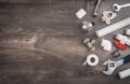 Adjustable wrench, plumbers tools and materials on the wooden background