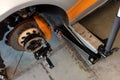 Adjusting the geometry of the car on the jack with a dismantled wheel. Royalty Free Stock Photo