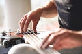 Adjusting guitar. Close-up of musician hands touching metal strings of guitar gently Royalty Free Stock Photo