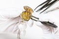 Adjusting of old pocket watch by tweezers Royalty Free Stock Photo