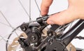Adjusting the tension of the bicycle brake caliper cable. Brake setting. Copy space for text. Close-up Royalty Free Stock Photo