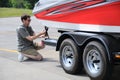 Adjusting Tie Down Straps On Boat Trailer Royalty Free Stock Photo