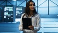 Admin in data center monitoring security threats with tablet