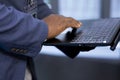Close up of worker in data center using laptop