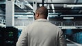 Admin walking in high tech data center facility, checking equipment Royalty Free Stock Photo