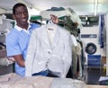 Administrator of laundry holding clean garments