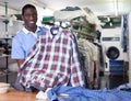 Administrator of laundry holding clean garments