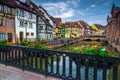 Admirable walkway decorated with flowers on the waterfront, Colmar, France