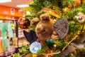 Admire the playful touch of a cute bat-shaped ornament, hanging from a beautifully decorated Christmas tree in a close-up shot