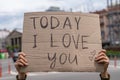 Admirer romantic declaration of love on the street cardboard lettering poster. Royalty Free Stock Photo