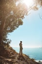 Admiring the natural beauty of the world. Rear view shot of a young woman admiring the view from the top of a mountain. Royalty Free Stock Photo