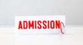 ADMISSIONS of the word on paper. concept. Words of ADMISSIONS on a wooden background Royalty Free Stock Photo