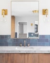 A bathroom with blue tiles and gold lights. Royalty Free Stock Photo