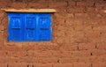 Adobe bricks wall blue shutter windows Royalty Free Stock Photo