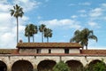 Adobe Casita with a Red Tile Roof and Palm Trees Royalty Free Stock Photo