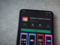 Adobe Creative Cloud app play store page on a smartphone on ceramic stone background Royalty Free Stock Photo
