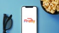 Adobe Firefly logo displayed on mobile phone screen, AI Art generator tool